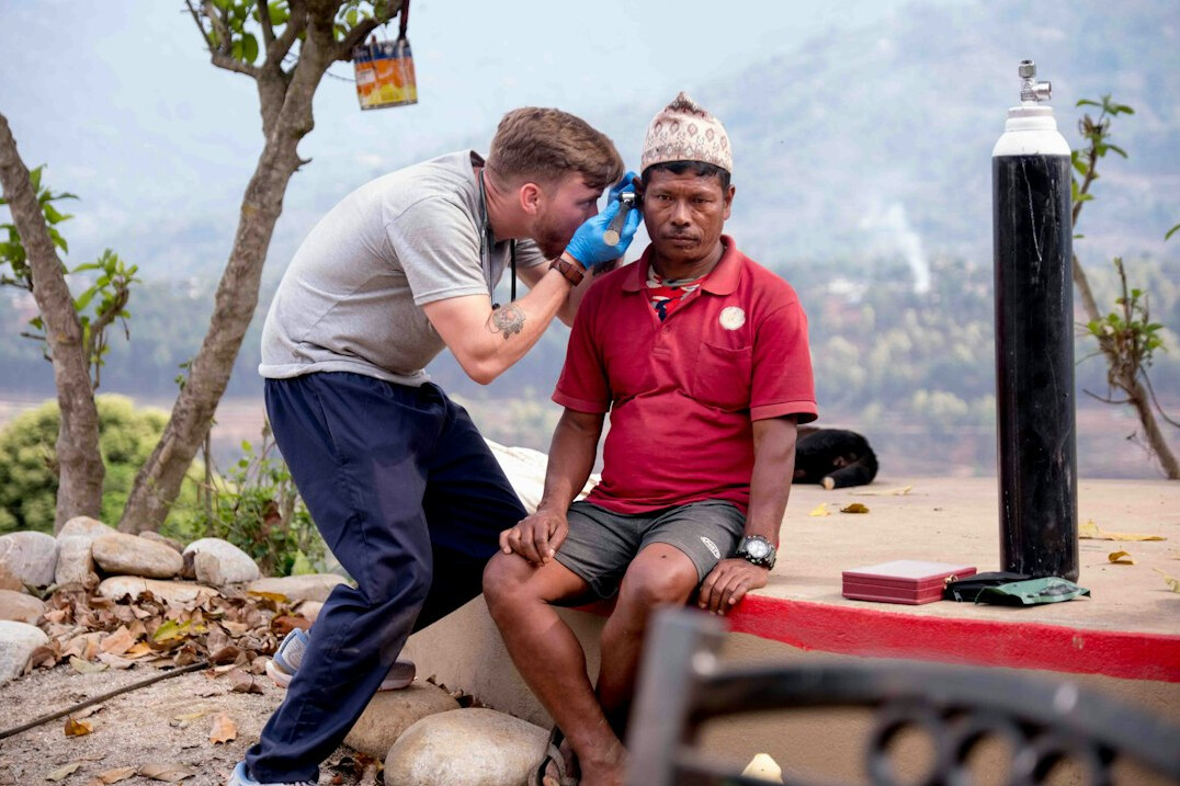 Trainer explaining a lighting setup to a student outdoors