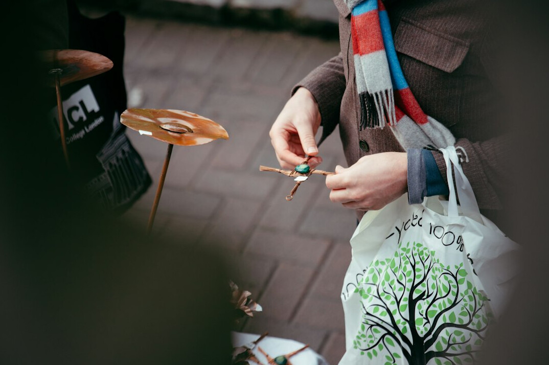 Person packing compact camera equipment into a small bag