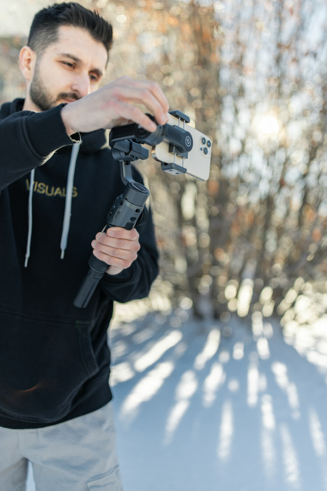 Person using a handheld gimbal stabilizer to balance a shot