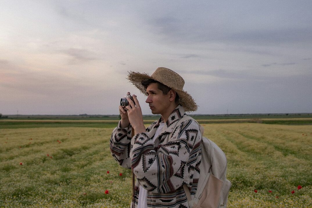 Reporter framing a shot in the field with a smartphone