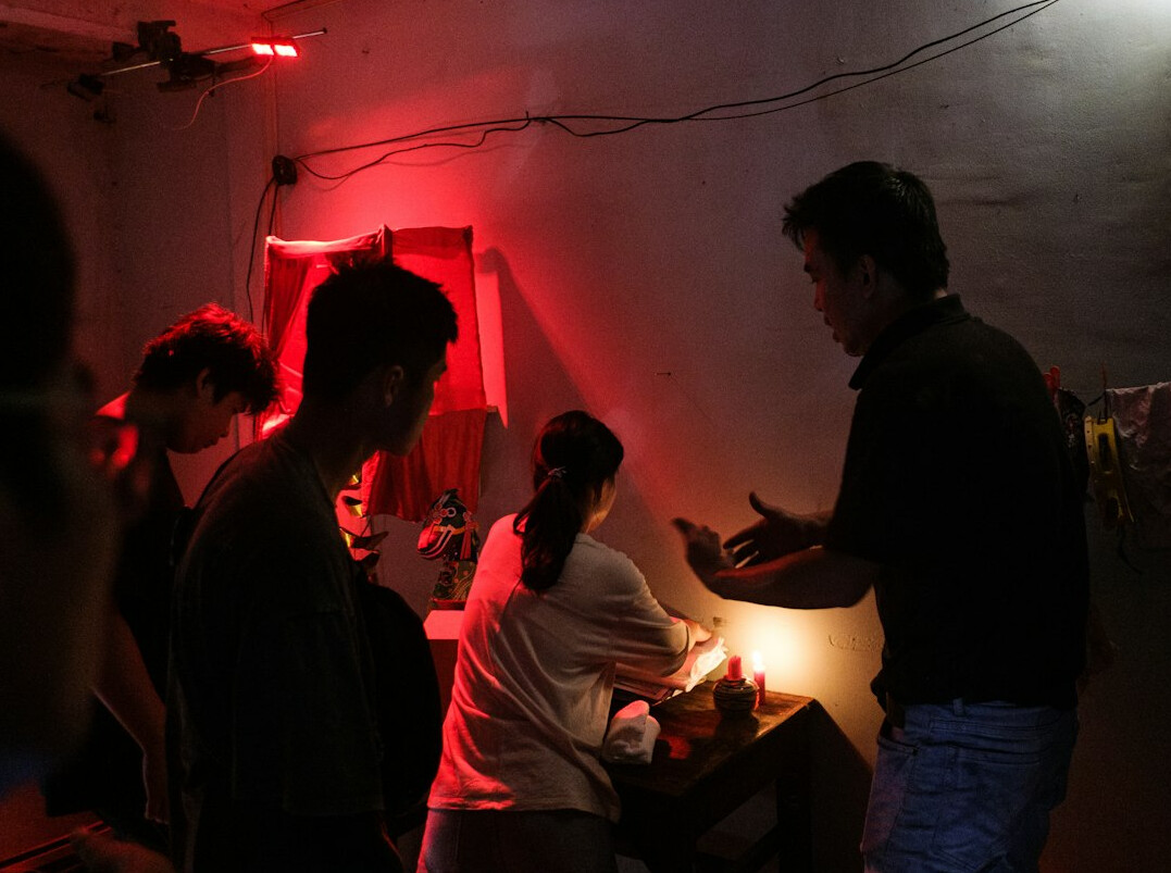Small group workshop session with trainees practicing lighting setups
