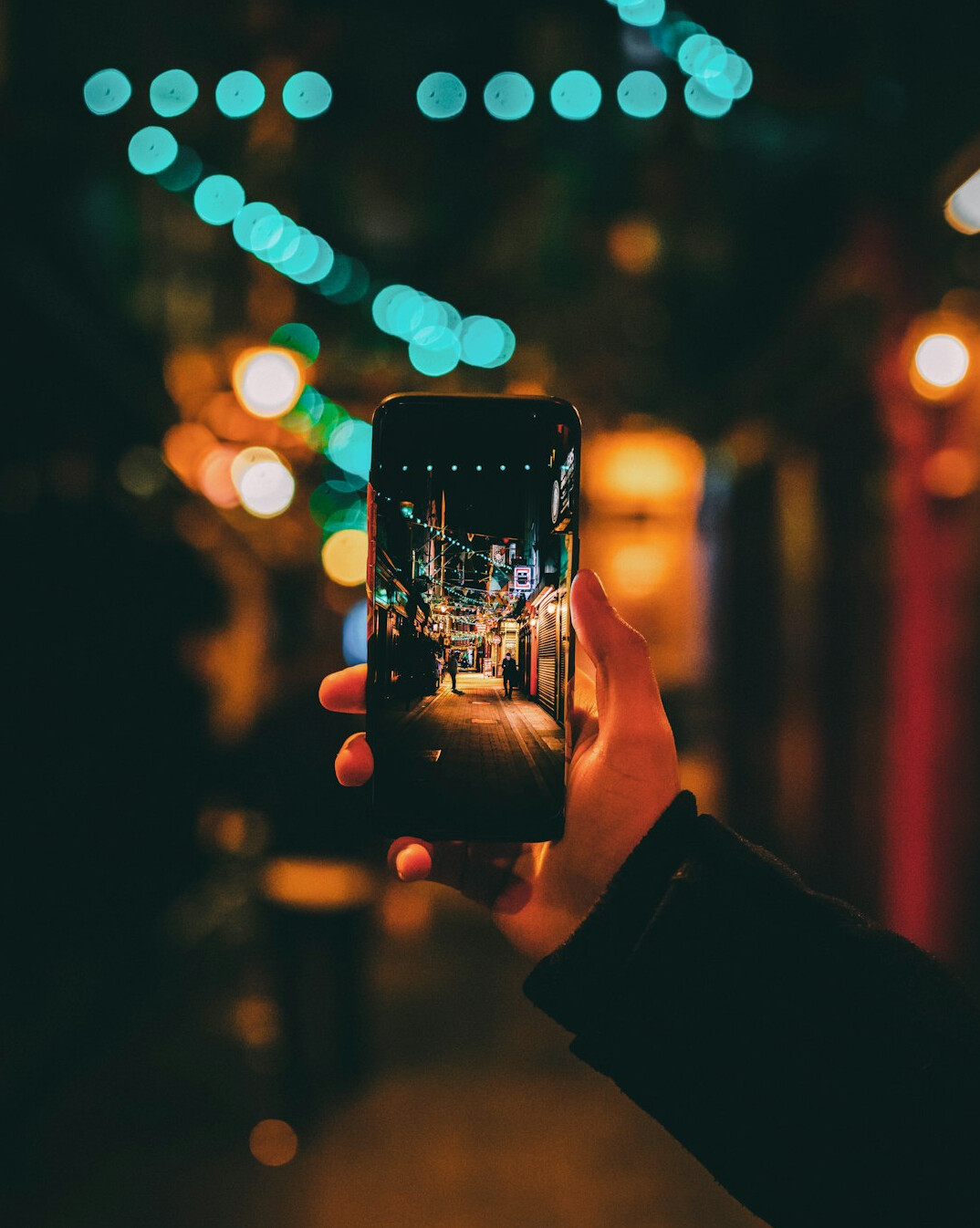 Reporter filming a scene in the city with a phone and light