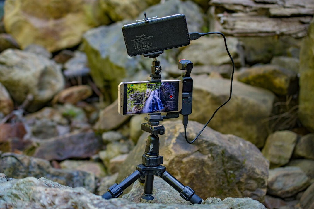 Smartphone mounted on a filming rig with microphone and light